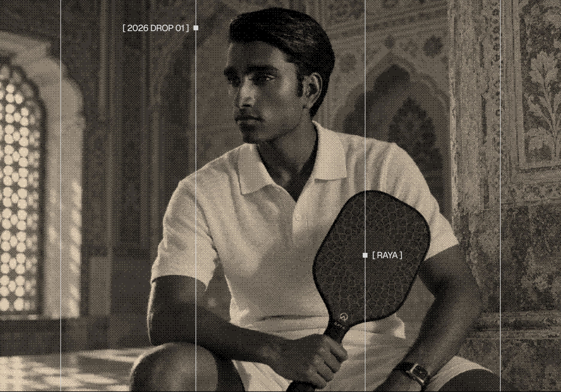 A player in a white polo holds the Raya Drop 01 paddle inside a carved Qutb Shahi interior